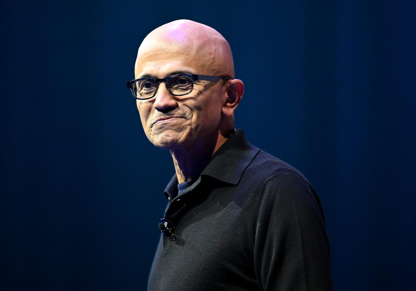 Man with glasses and a black collared shirt