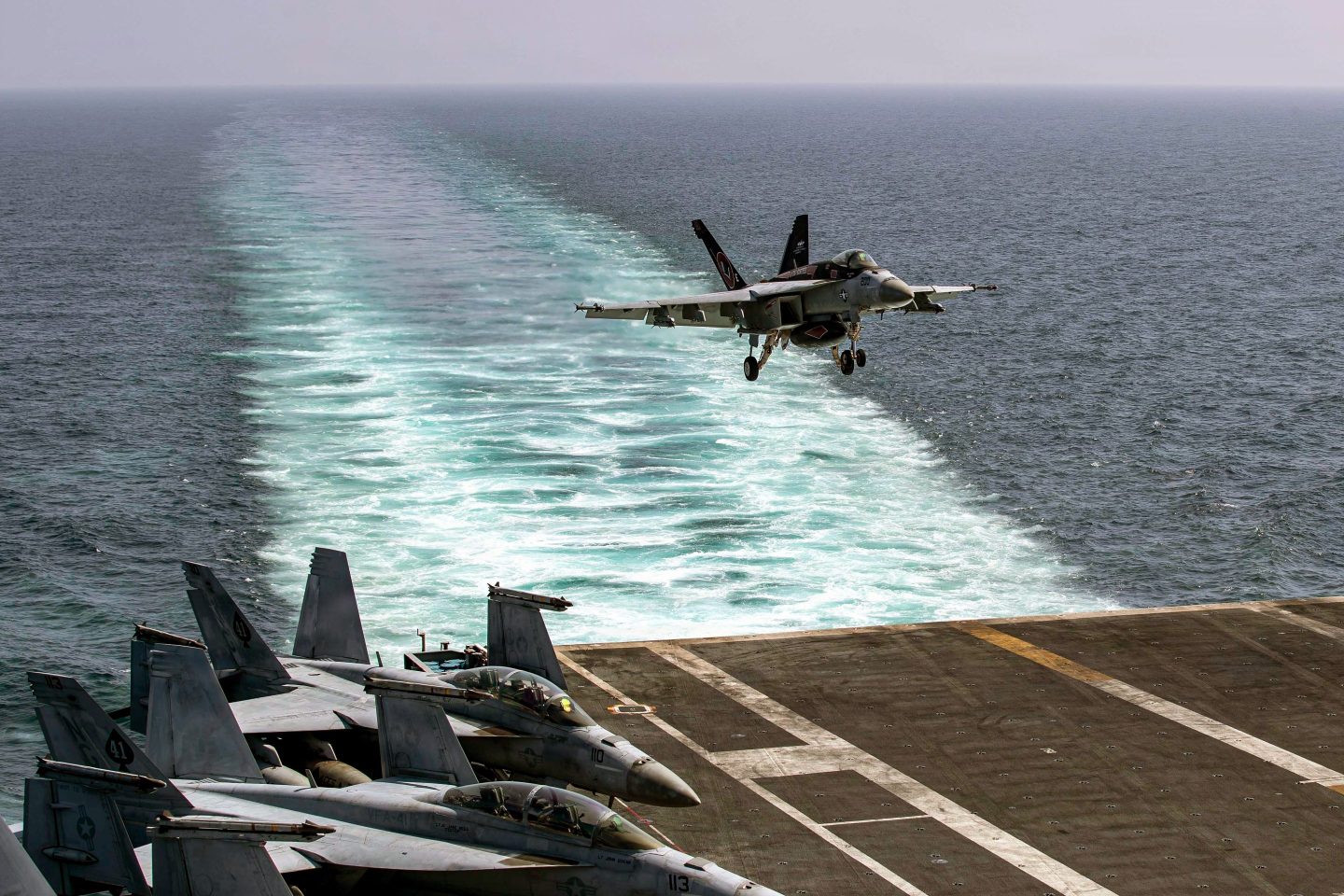 An F/A-18E Super Hornet, attached to Strike Fighter Squadron (VFA) 14, makes an arrested landing on the flight deck of Nimitz-class aircraft carrier USS Abraham Lincoln