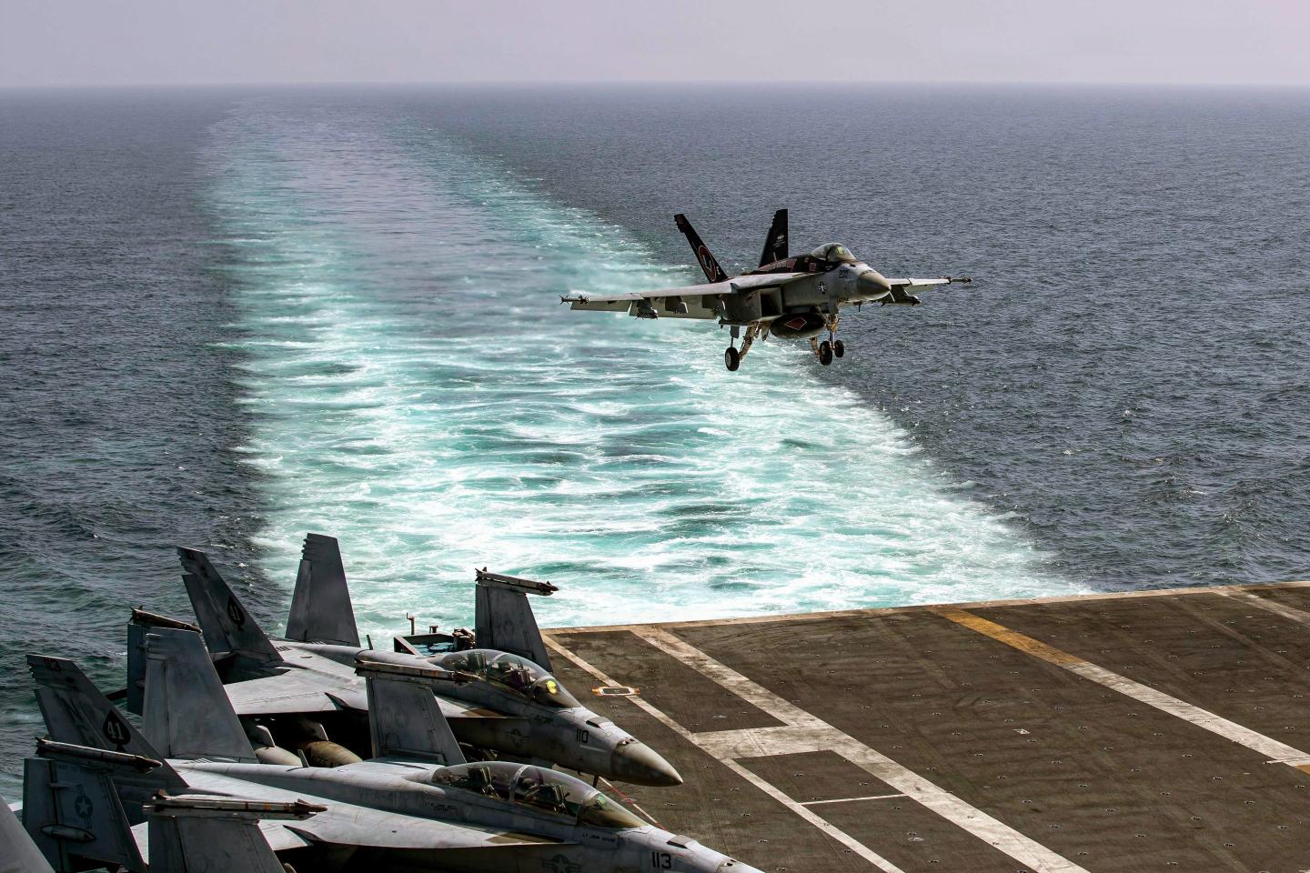 An F/A-18E Super Hornet, attached to Strike Fighter Squadron (VFA) 14, makes an arrested landing on the flight deck of Nimitz-class aircraft carrier USS Abraham Lincoln