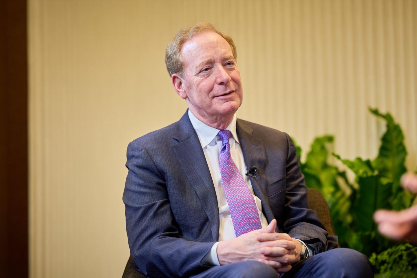 Microsoft President Brad Smith sitting.