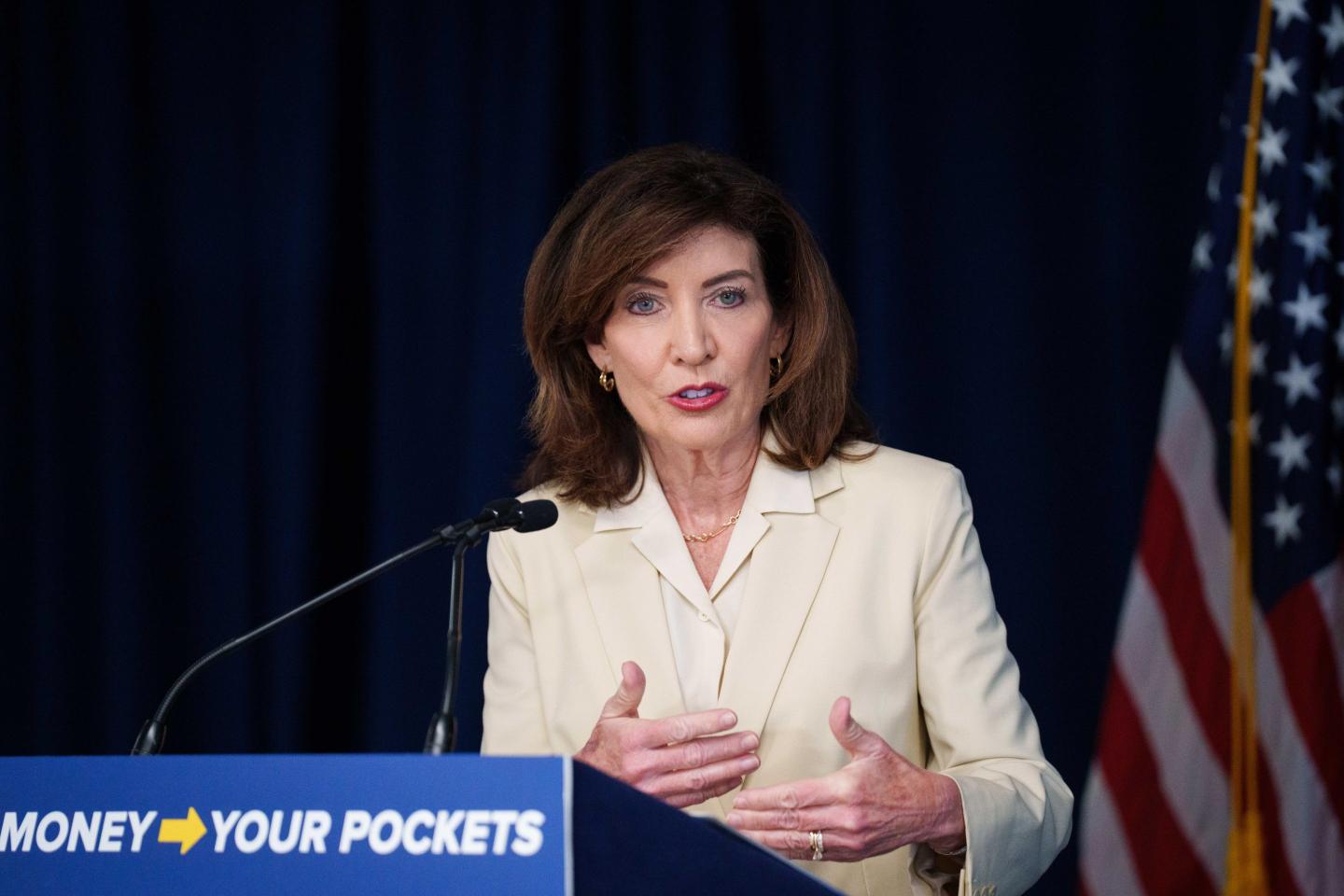 NYS Gov. Kathy Hochul standing at a podium