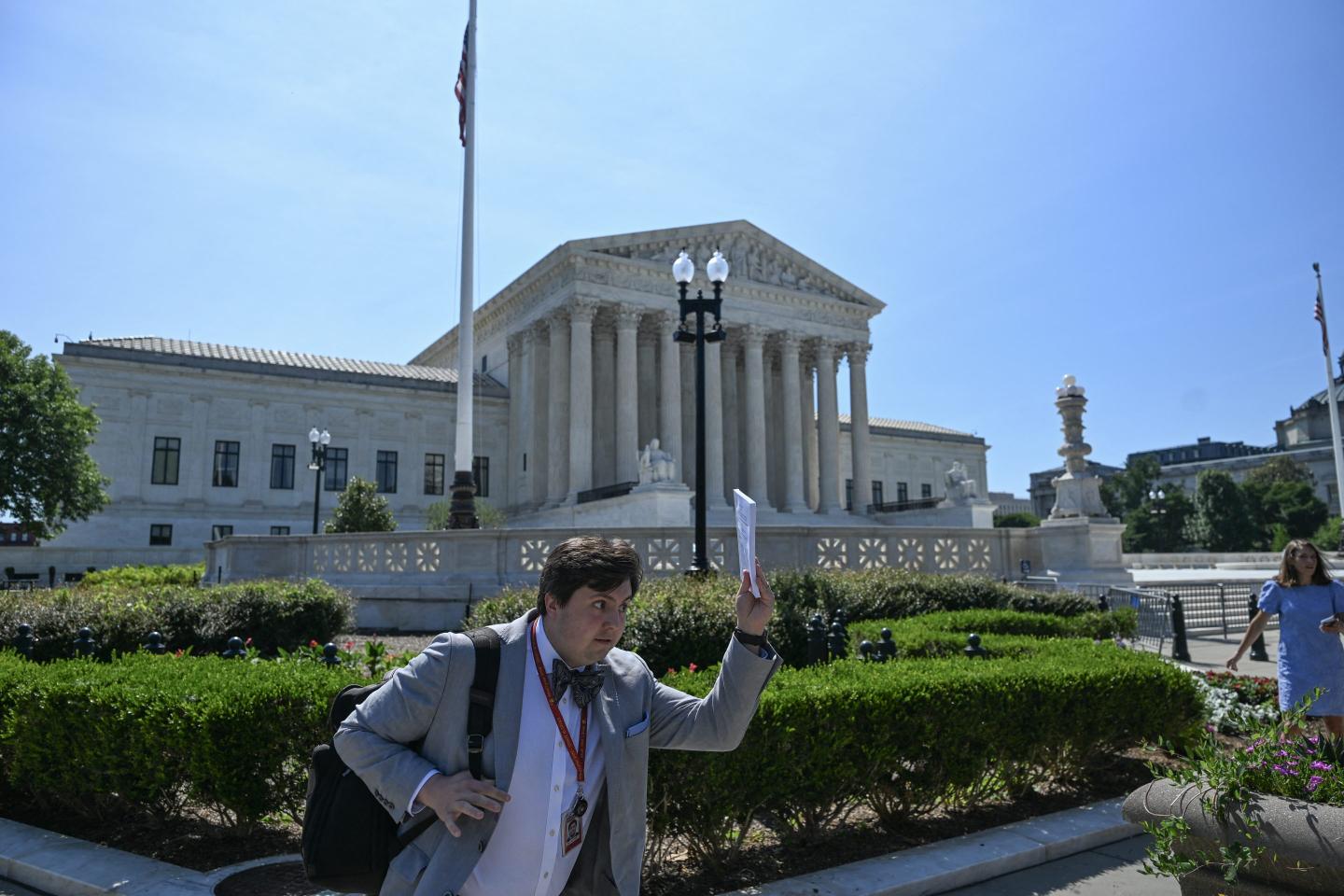 A reporter runs outside the Supreme Court as the court  ejected President Donald Trump's bid to restrict birthright citizenship on June 30, 2026. 