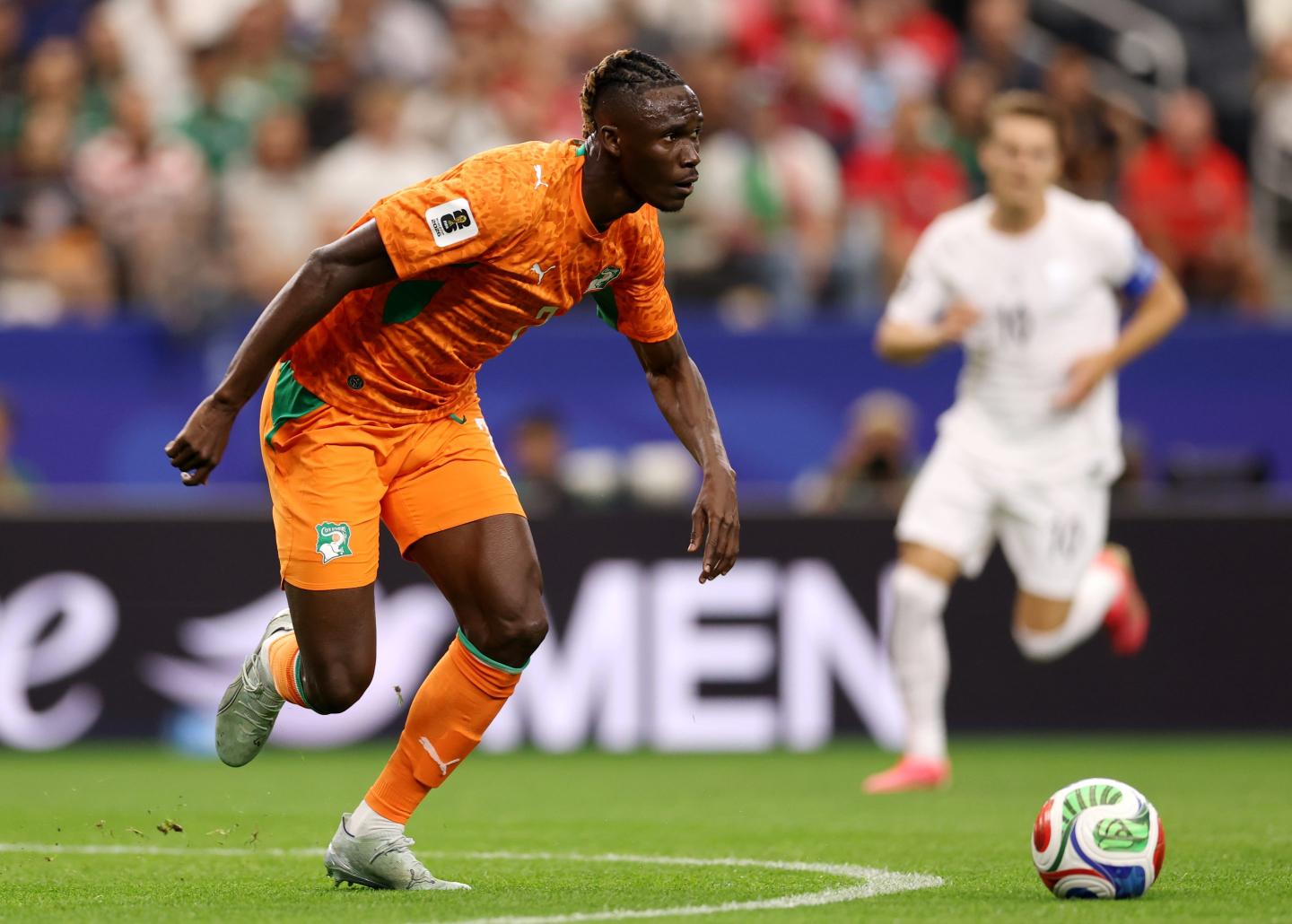 Odilon Kossounou #7 of Cote d'Ivoire plays in a World Cup match in front of a Dove for men ad