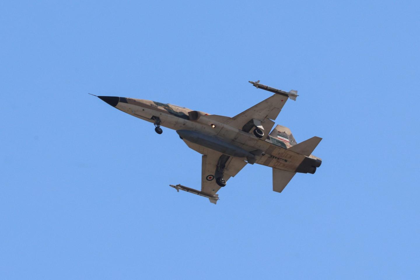 An Iranian Northrop F-5E Tiger II fighter jet performs a flyby over mourners taking part in a funeral procession for Iran's slain supreme leader Ali Khamenei.