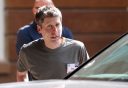 Sam Altman getting into a car