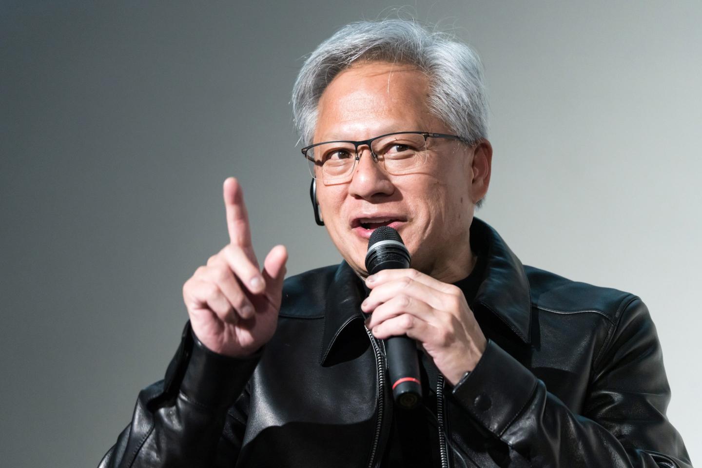 Jensen Huang speaks into a microphone