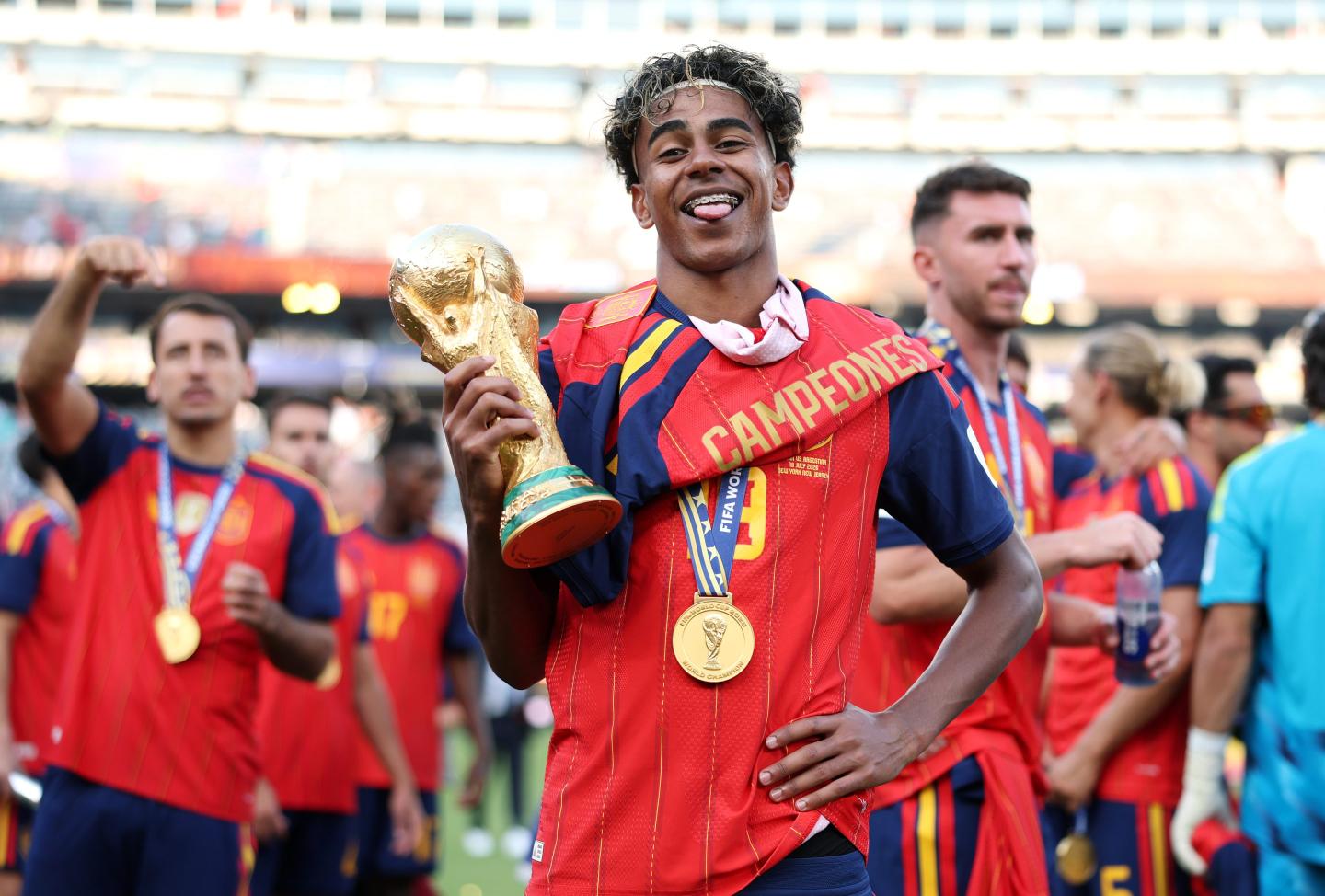 Lamine Yamal of the Spanish National Team poses with the FIFA World Cup trophy following Spain's victory in the World Cup Final.