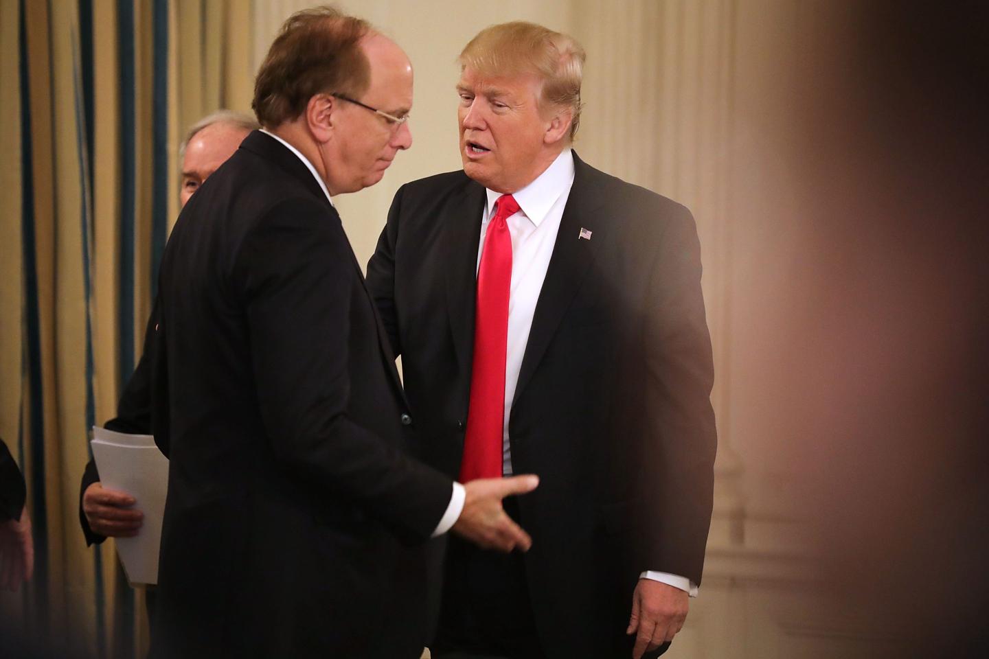 President Donald Trump and BlackRock CEO Larry Fink at the beginning of a policy forum in the State Dining Room at the White House on February 3, 2017.