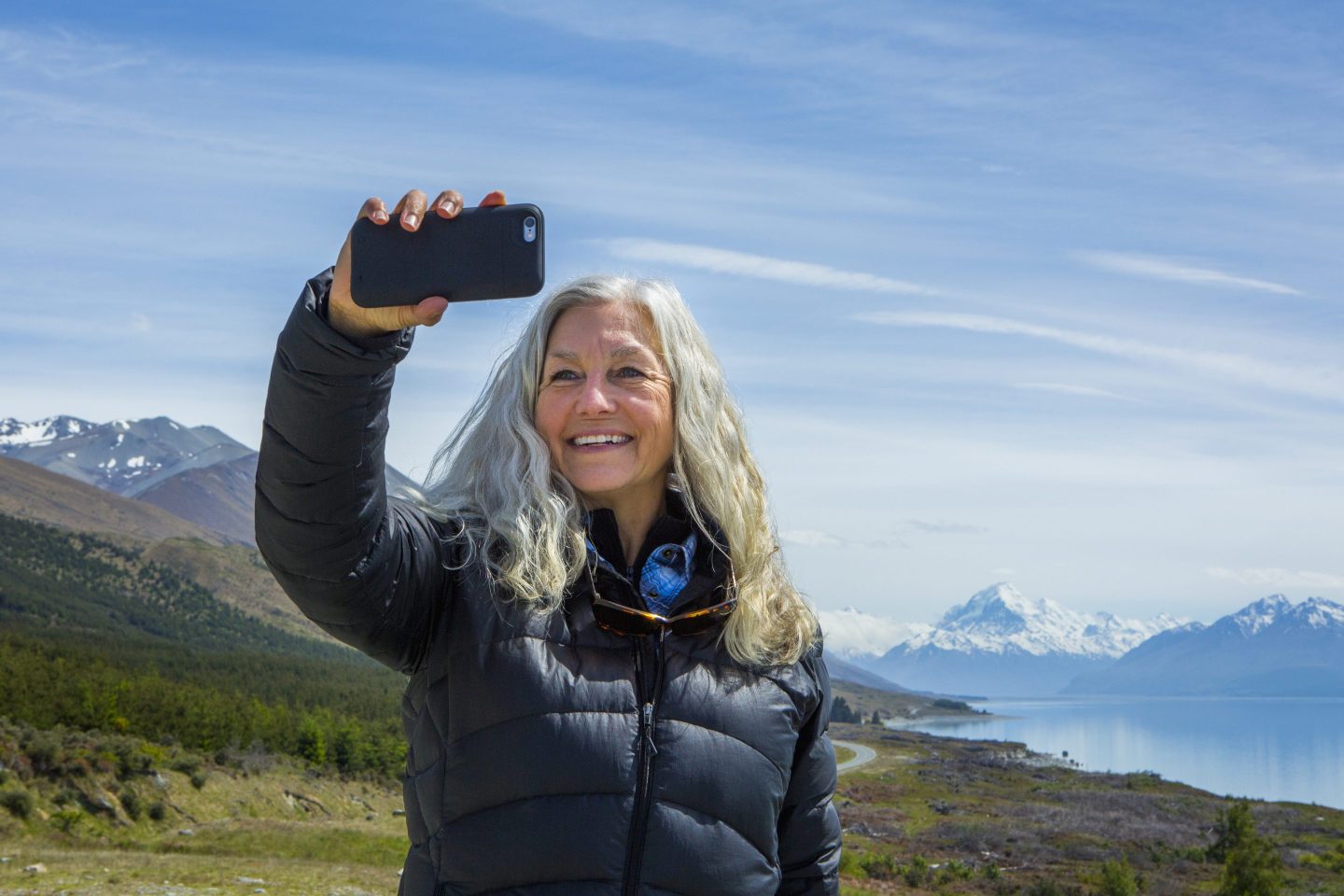 Woman taking photo in scenic landscape
