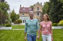 American couple walking in front of London mansion