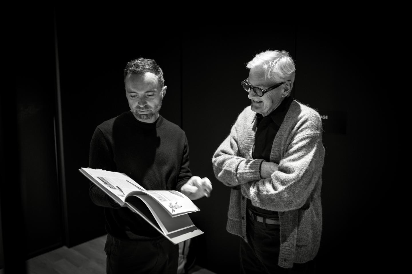 David Senra (left) holds a book while James Dyson (right) looks at the page