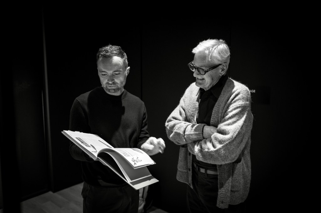 David Senra (left) holds a book while James Dyson (right) looks at the page