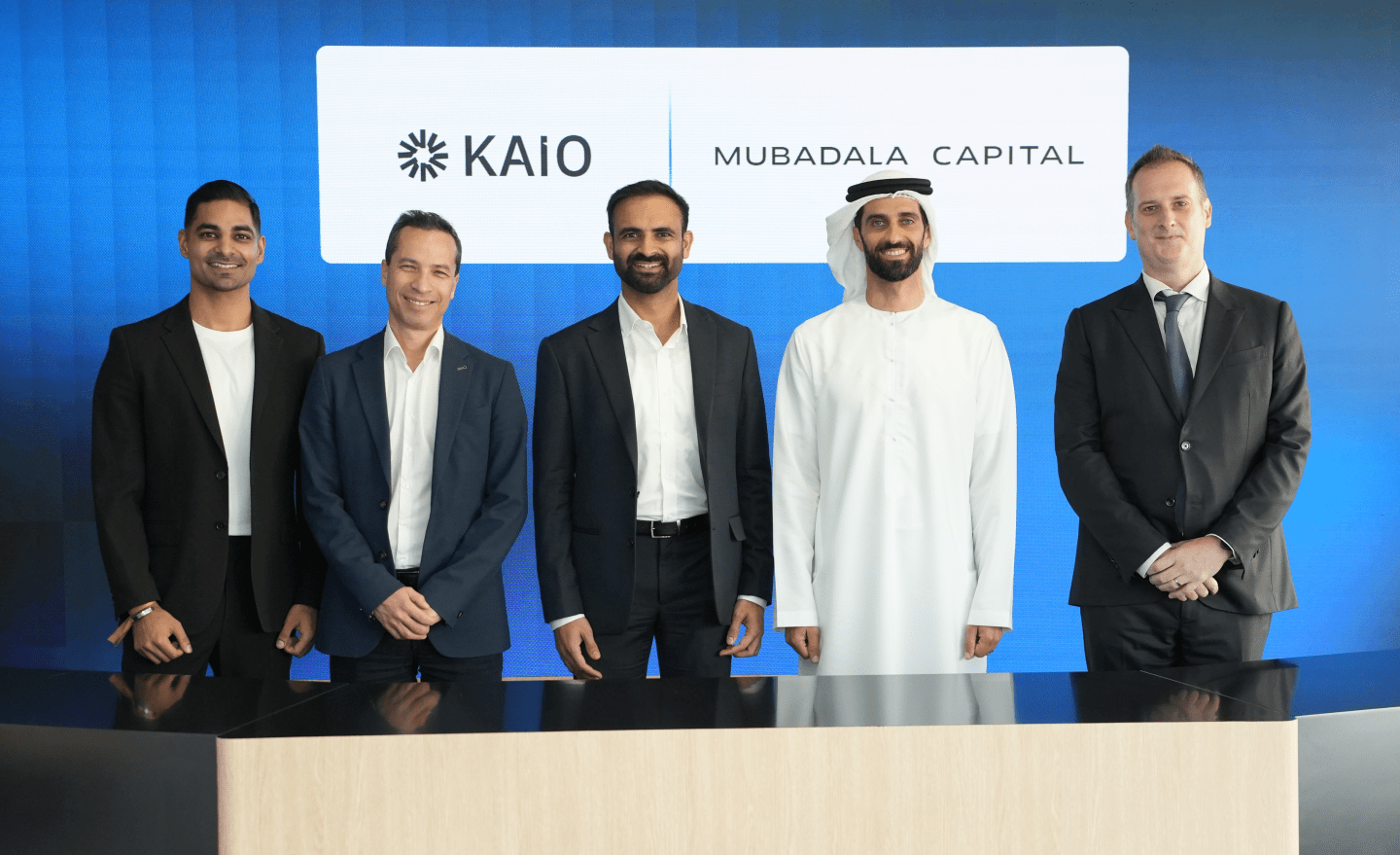 Members of KAIO and Mubadala Capital stand side by side smiling at the camera.