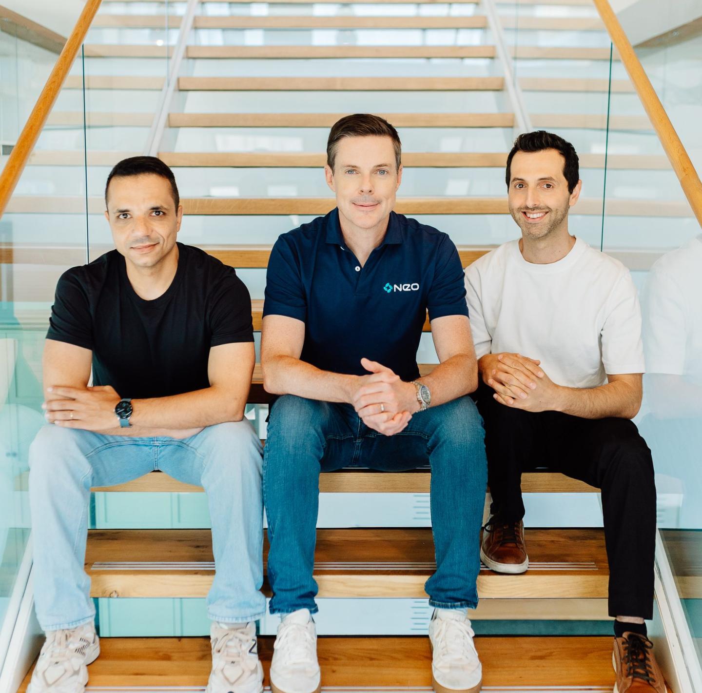 Three people sitting on stairs