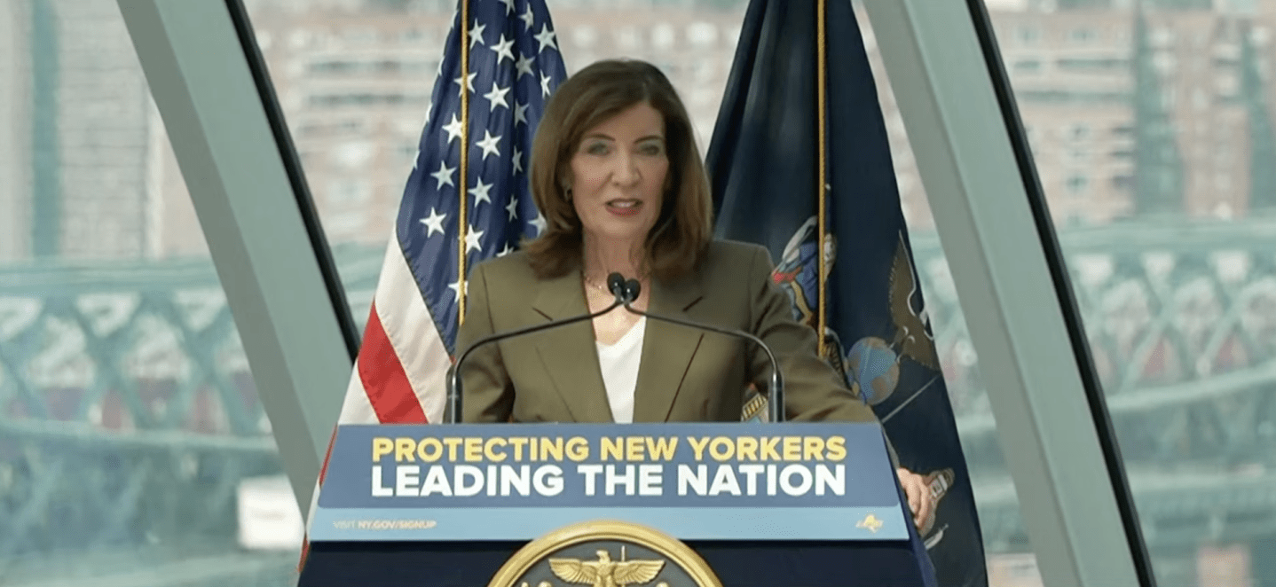 NYS Gov. Kathy Hochul standing at a podium