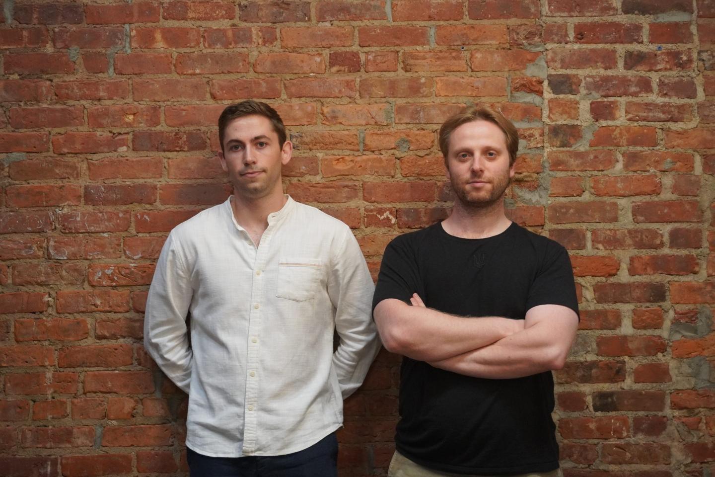 Pascal cofounders Matthew Downey (left) and Ivo Crnkovic-Rubsamen (right) stand side by side against a brick wall.