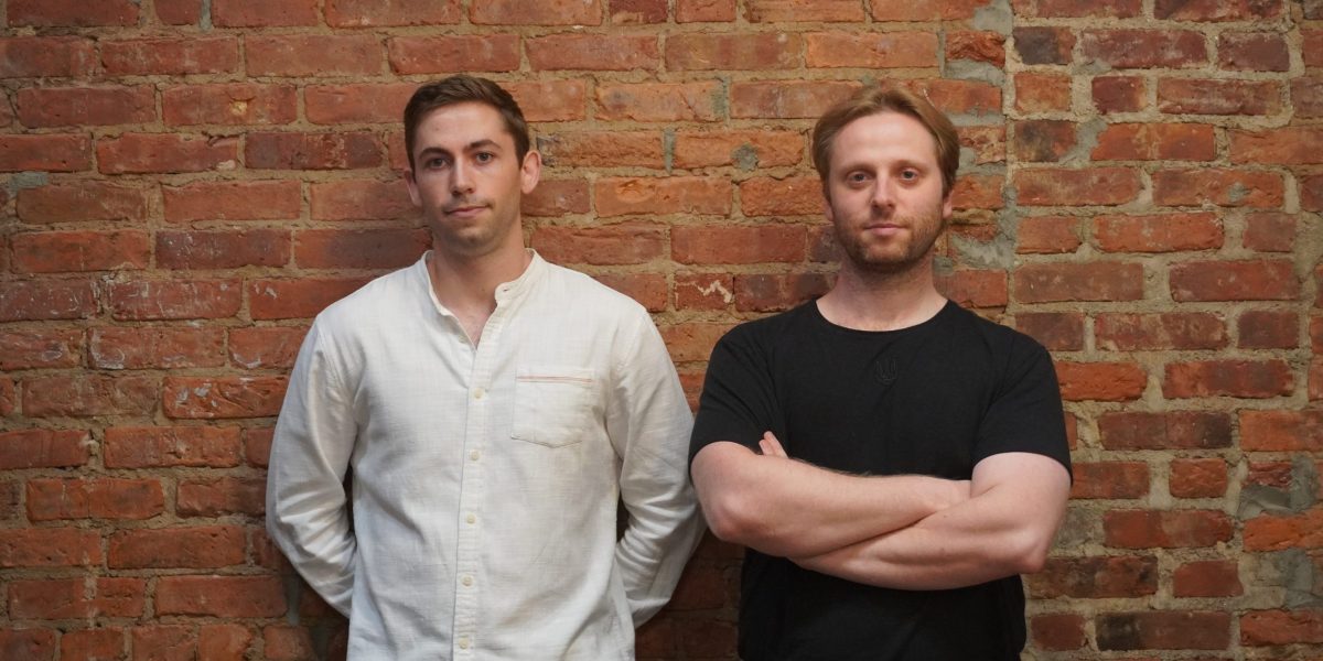 Pascal cofounders Matthew Downey (left) and Ivo Crnkovic-Rubsamen (right) stand side by side against a brick wall.
