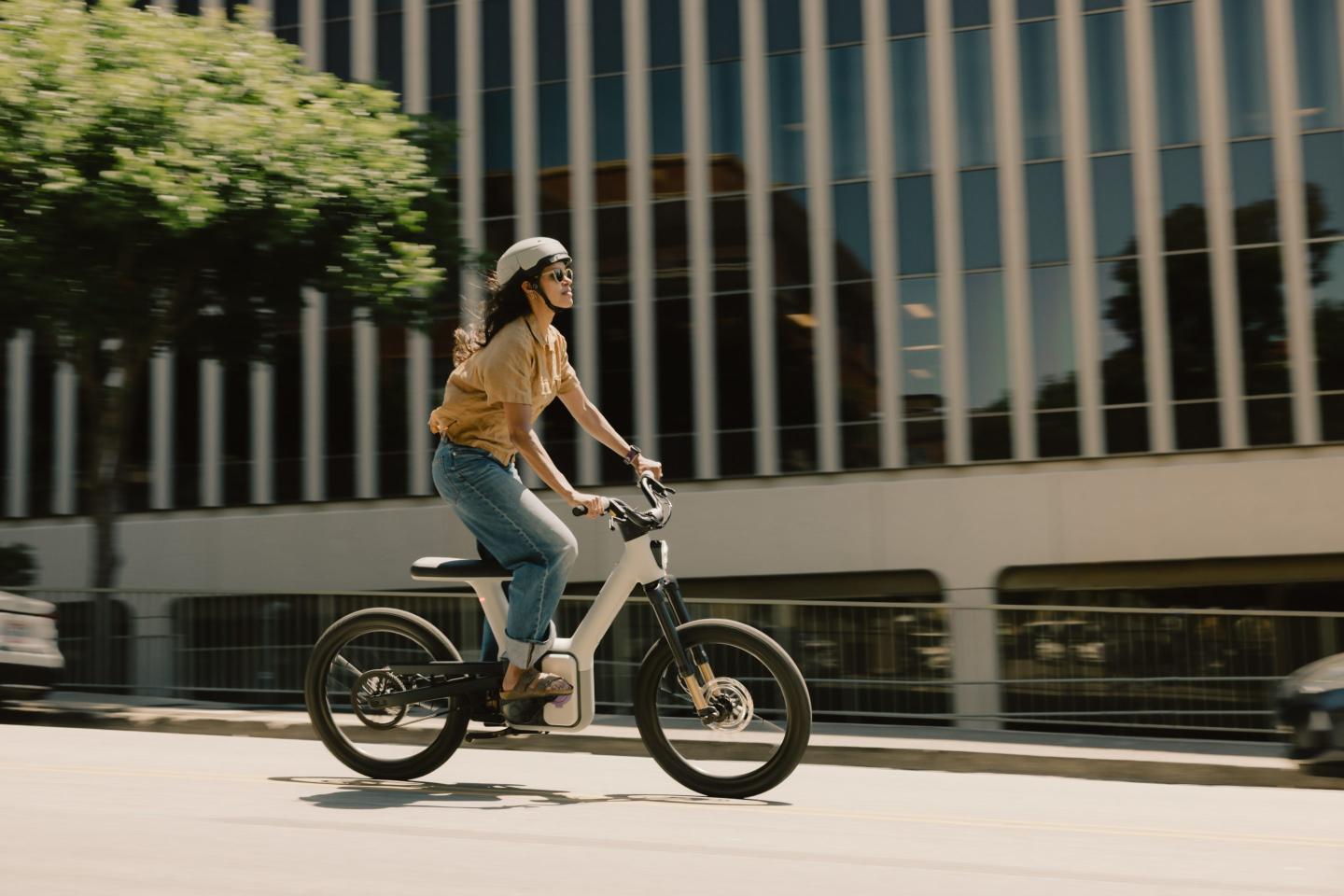 a woman rides an ALSO autonomous bike