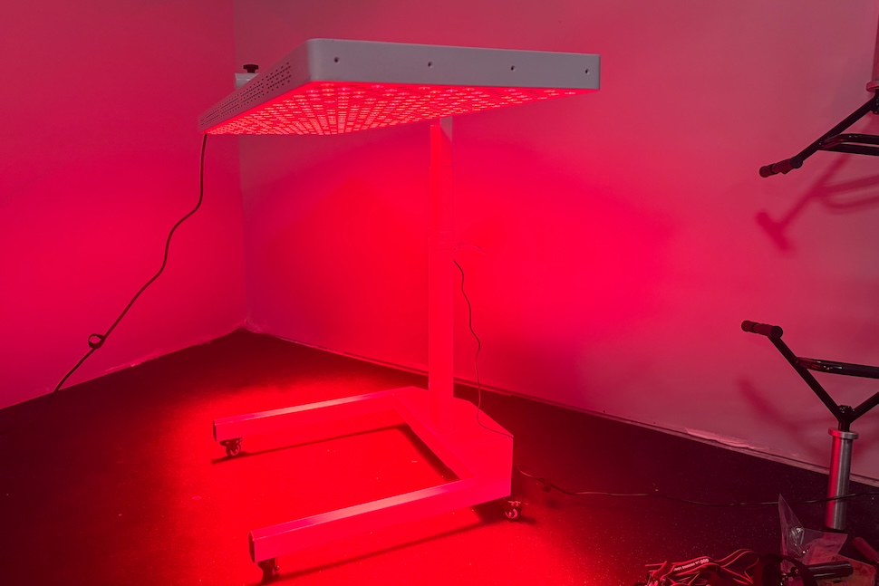 The Helio Nova red light therapy panel switched on and turned in the horizontal positin