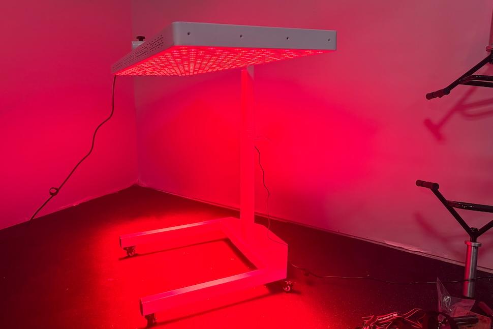The Helio Nova red light therapy panel switched on and turned in the horizontal positin