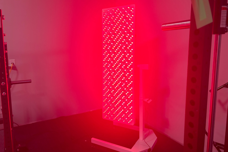 The Helio Nova red light therapy panel, turned on and glowing