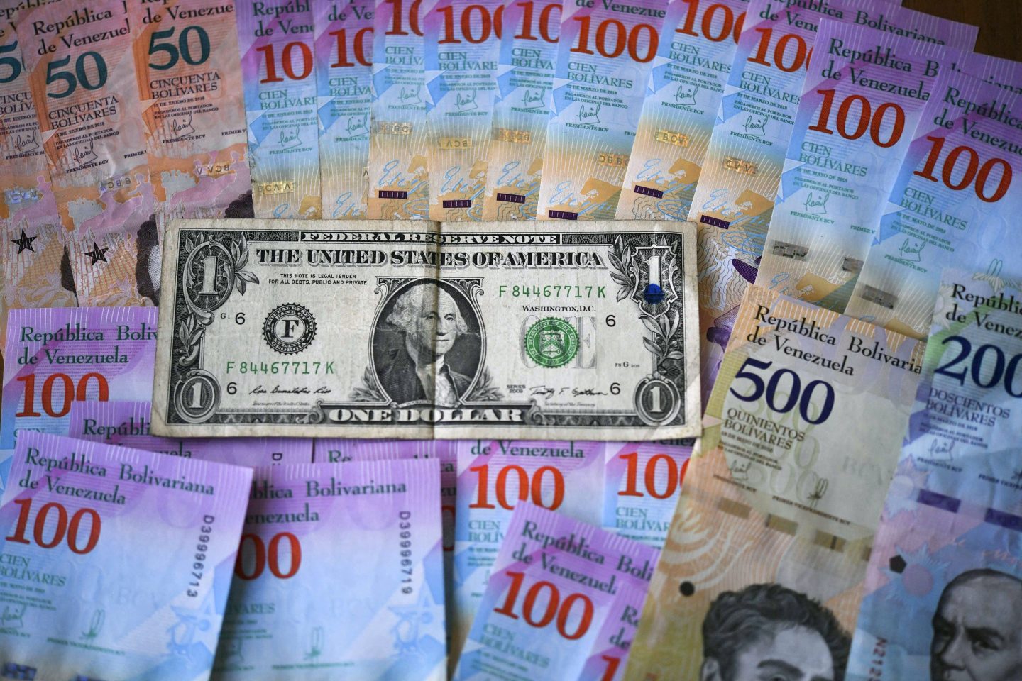 Venezuelan Bolivar banknotes and a US one-dollar bill in Caracas on January 28, 2019.