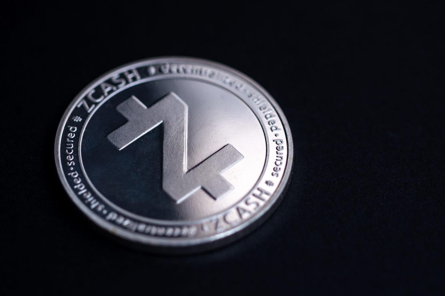 Studio shot of a silver zcash coin against a black backdrop.