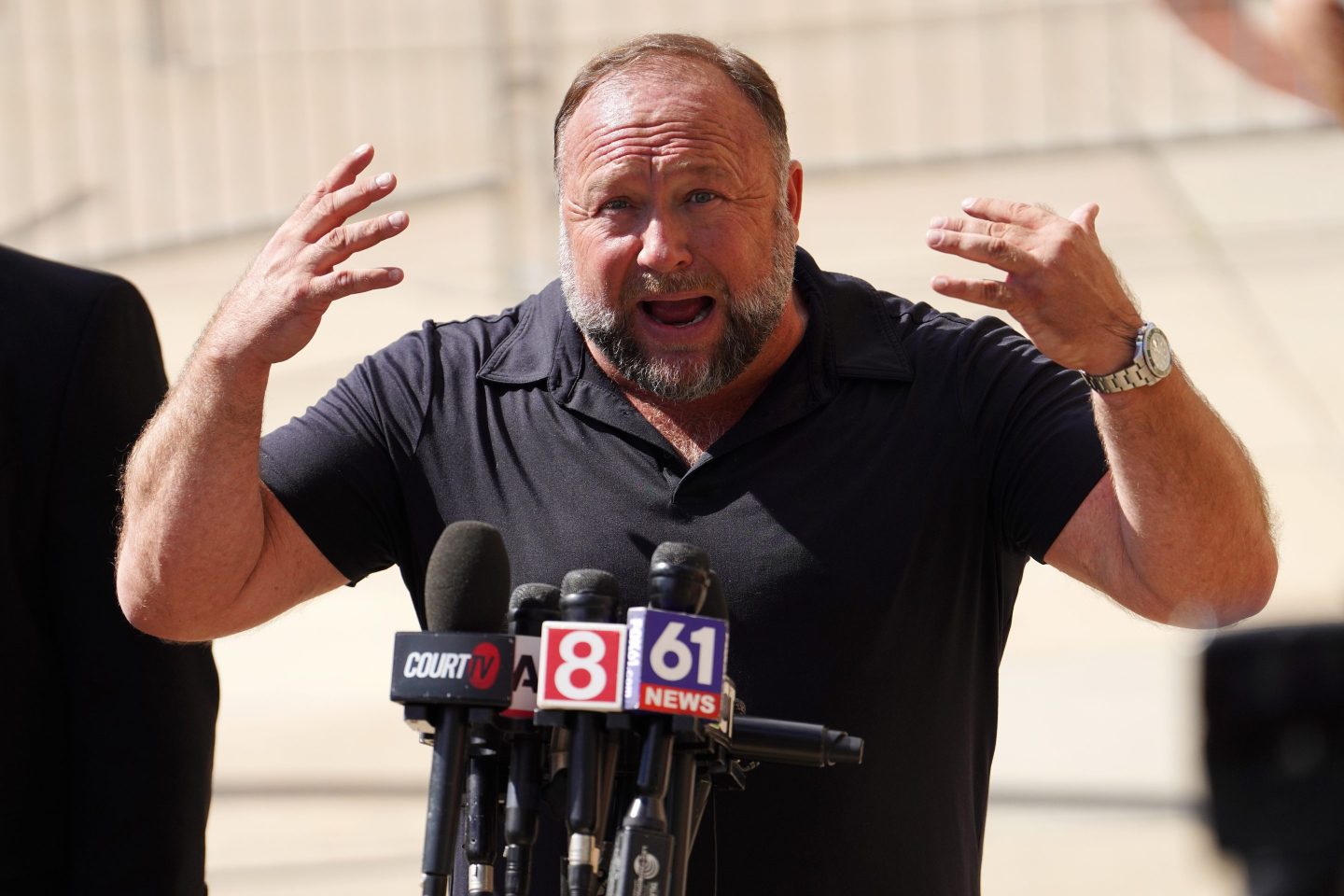 InfoWars founder Alex Jones speaks to the media outside Waterbury Superior Court during his trial.