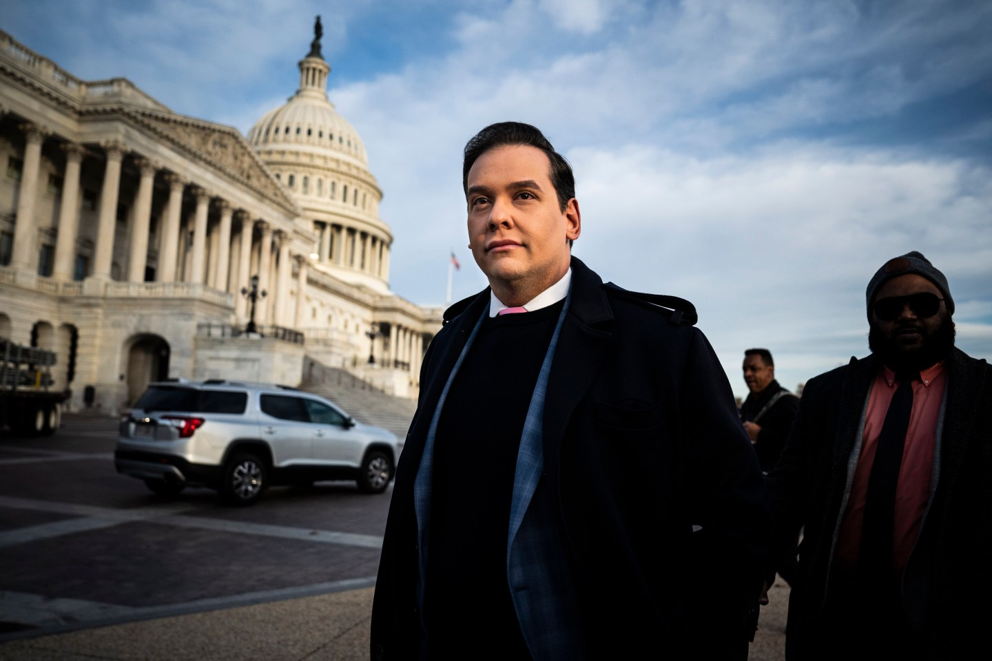 George Santos stands in front of the US Congress on Capitol Hill.