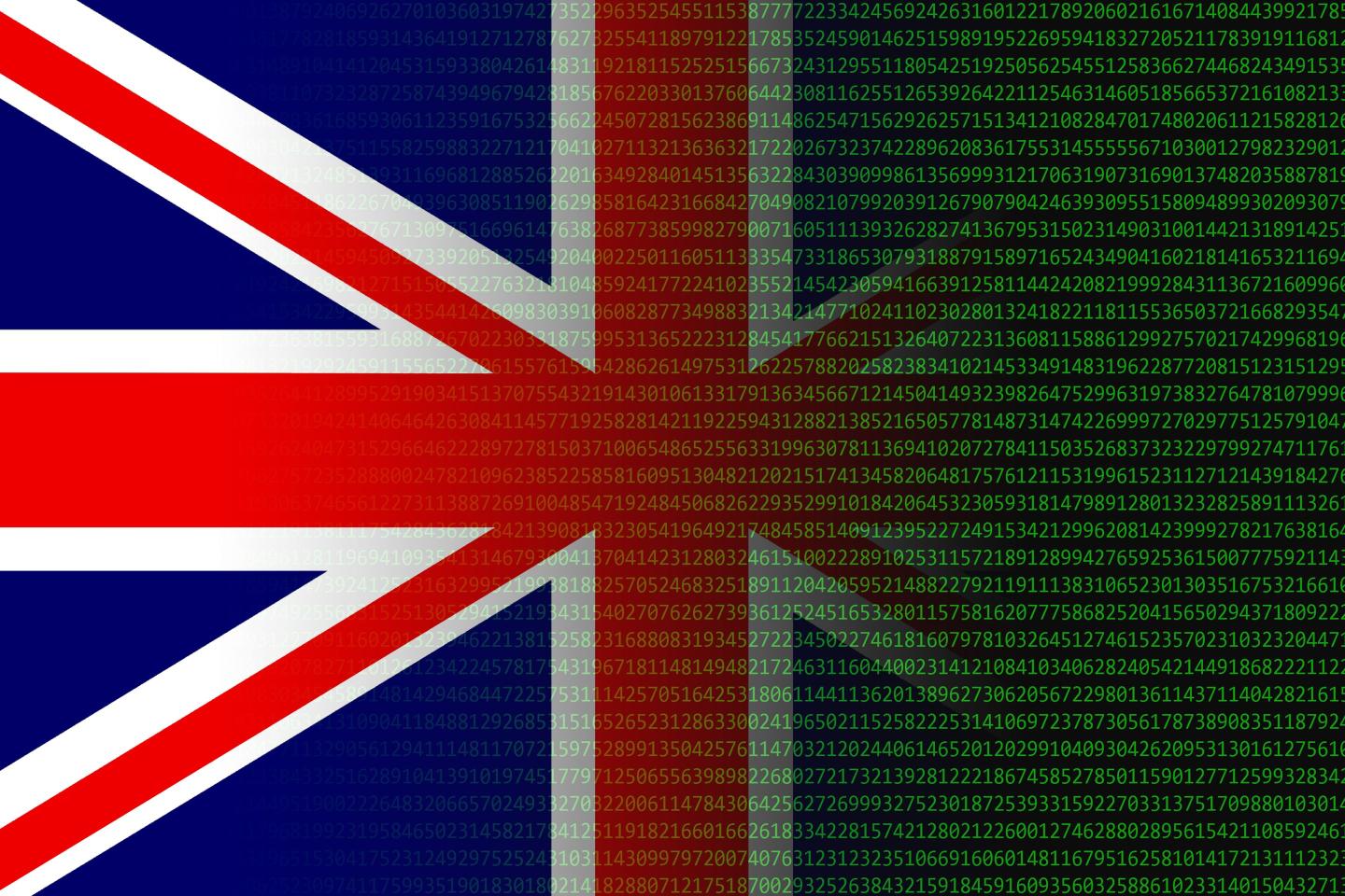 Photo of British flag blending into computer code in green type on a black screen.