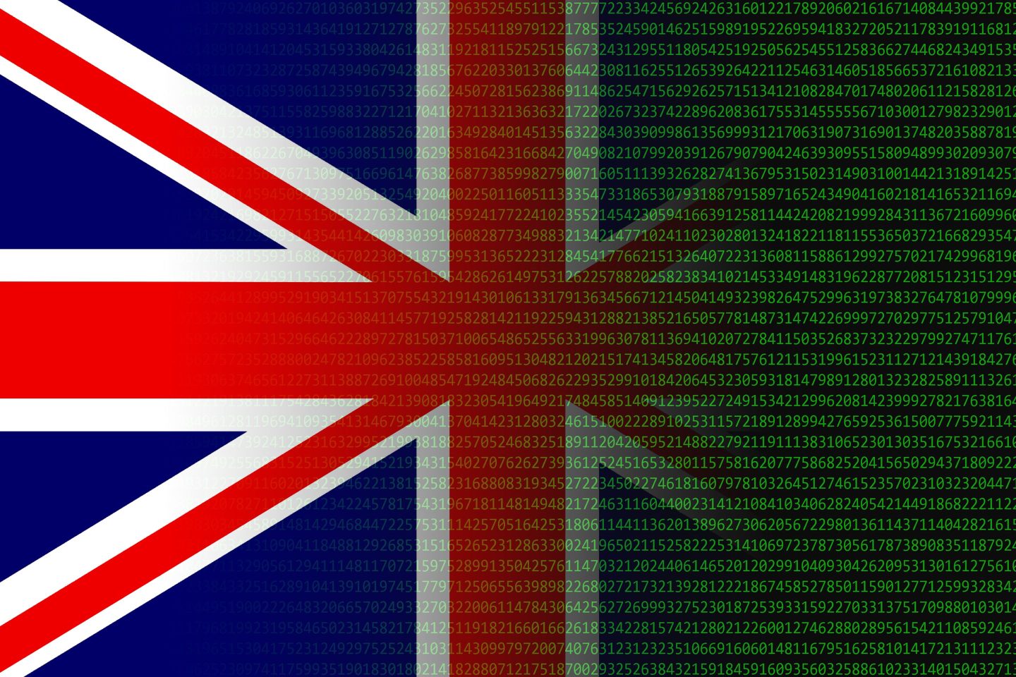 Photo of British flag blending into computer code in green type on a black screen.