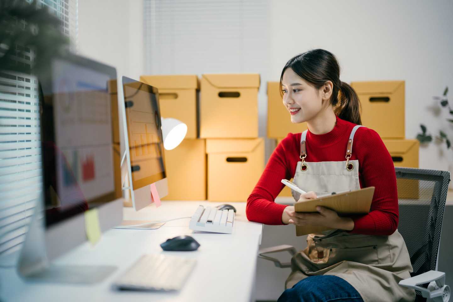 A person sitting a desk looking at a computer screen.