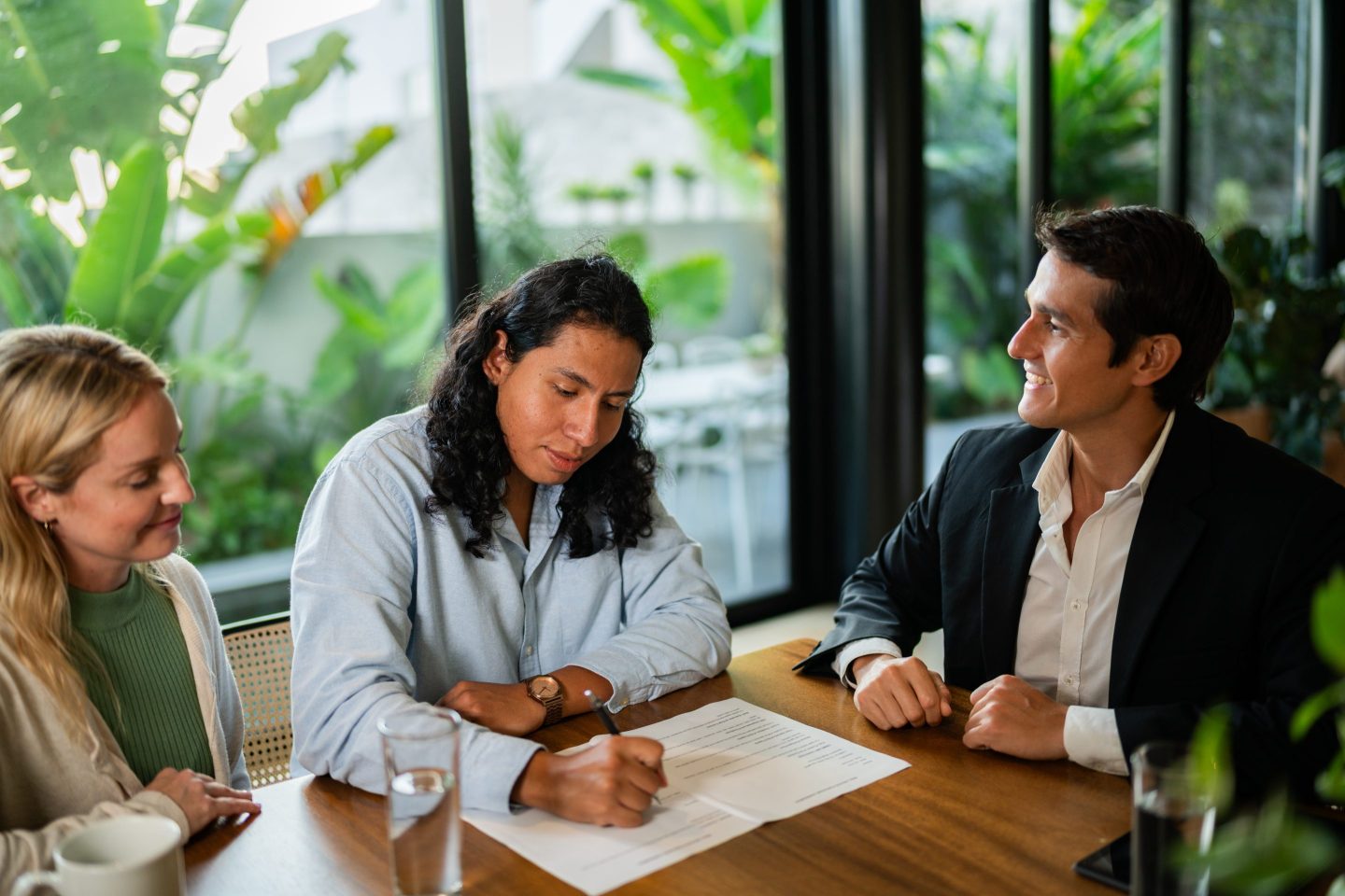 Two men and a women review a resume