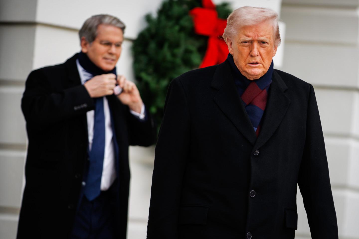 US President Donald Trump, right, followed by Scott Bessent, US treasury secretary, exit the South Portico of the White House before boarding Marine One in Washington, DC, US, on Saturday, Dec. 13, 2025.