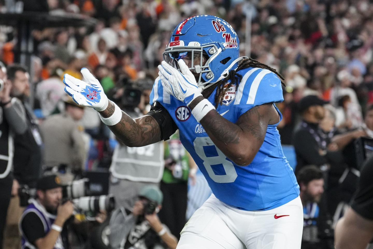 Dae'quan Wright #8 of the Ole Miss Rebels celebrates against the Miami Hurricanes during the second half of CFP Semifinal Vrbo Fiesta Bowl at State Farm Stadium.