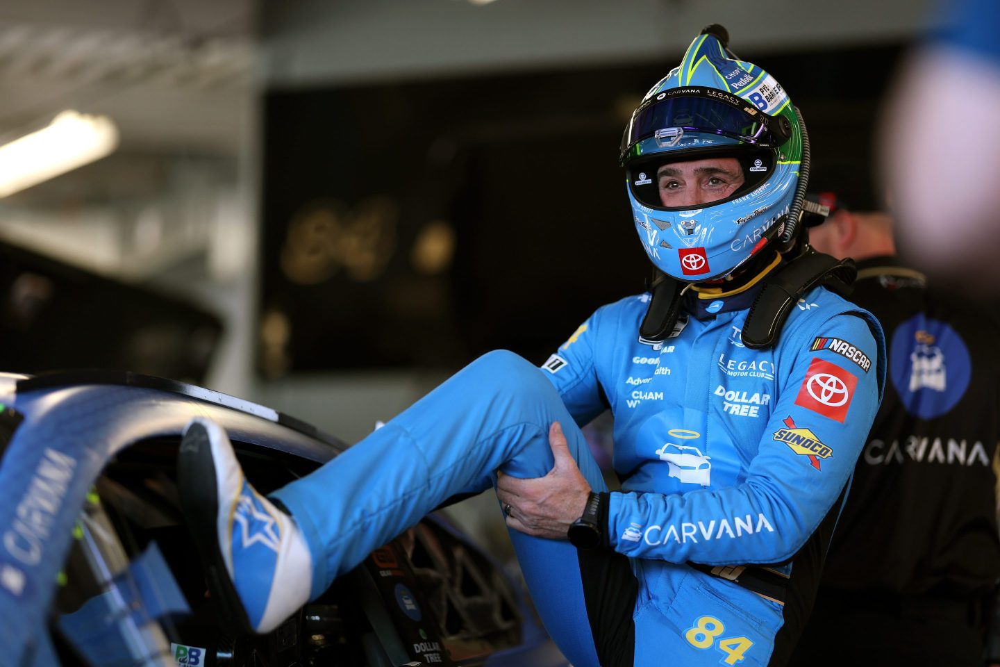 Jimmie Johnson, driver of the #84 Carvana Toyota, enters his car in the garage area during practice