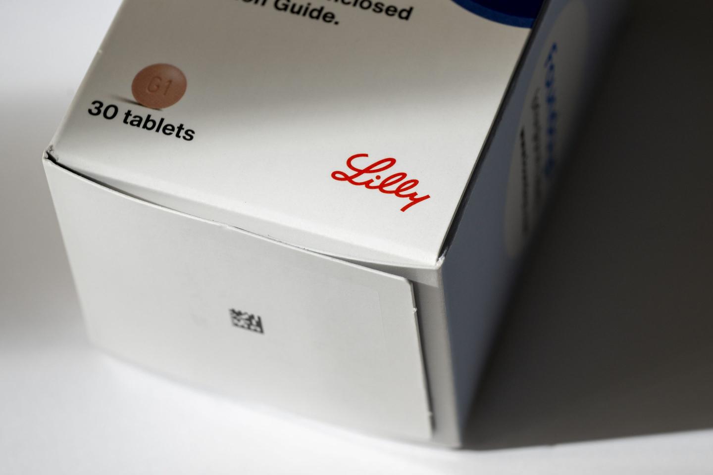 photo illustration of the Eli Lilly logo on a box of the new Foundayo weight loss oral pill.
