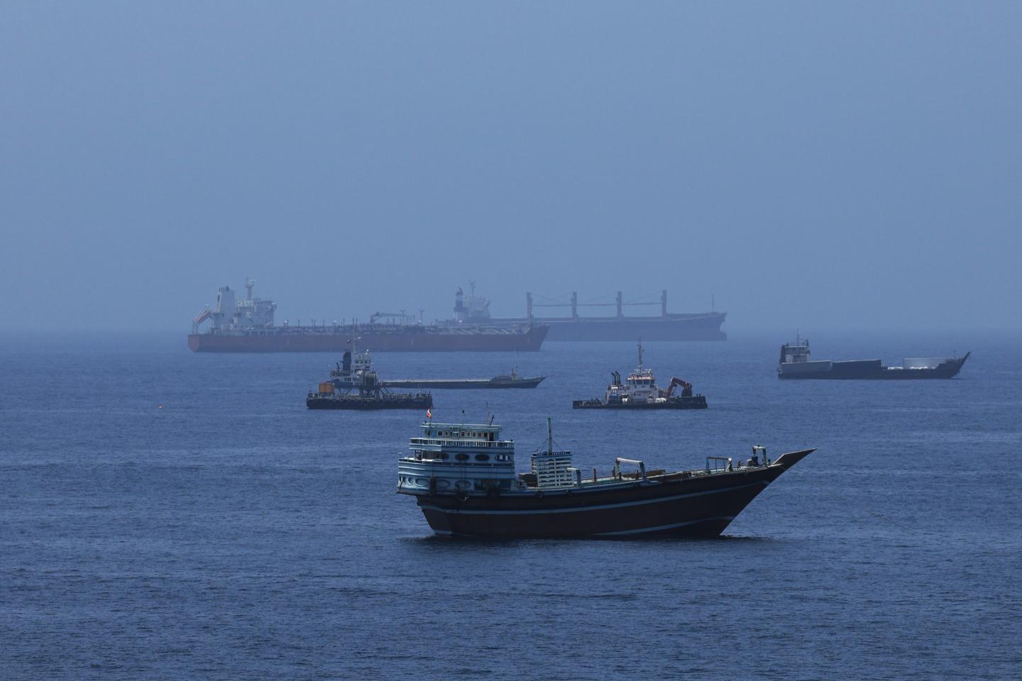 A view of commercial cargo vessels and crude oil tankers are anchored in the Gulf of Oman, off the coast of Muscat, Oman