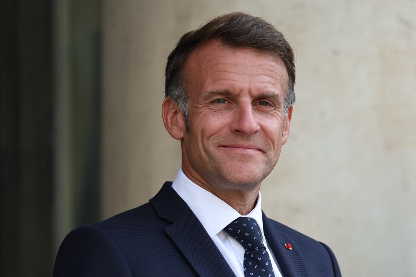 France's President Emmanuel Macron reacts as he welcomes European Commission President.