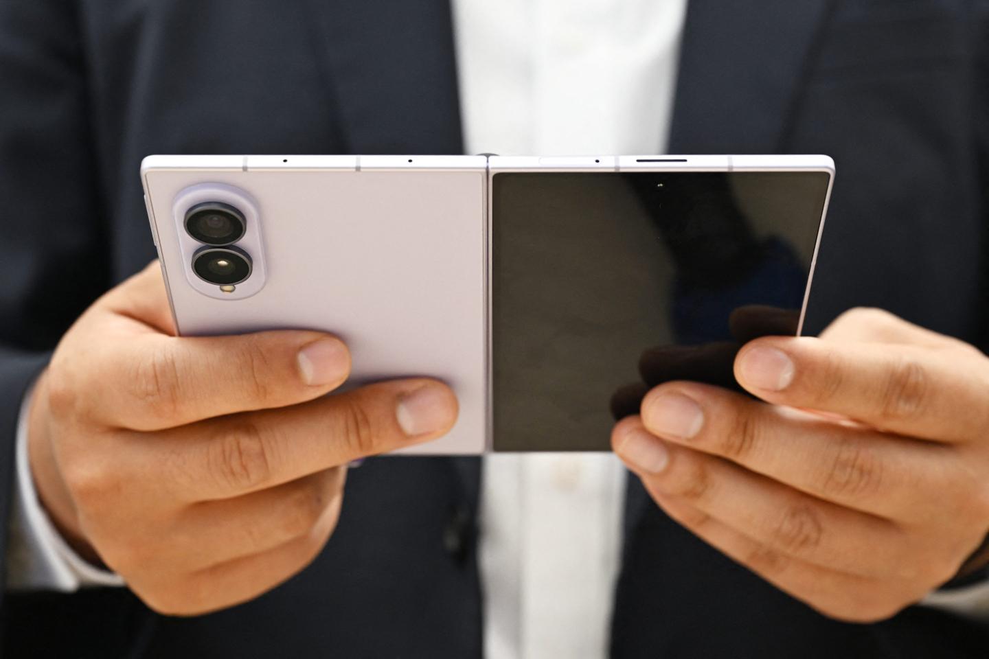 A customer tries out a newly-released Samsung Galaxy Z Fold8 smartphone at a Samsung store.