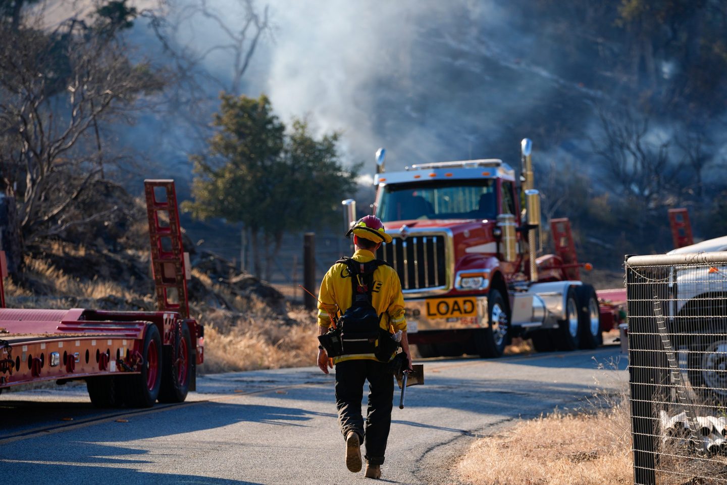 A firefighter walks near burning areas as crews battle with wildfire named as 'Mines Fire' in Santa Clara County.