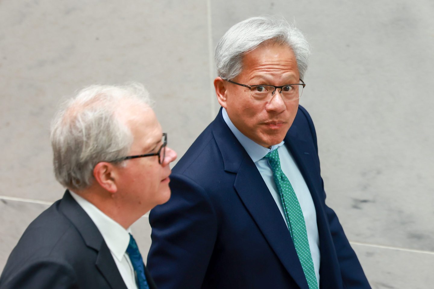 Jensen Huang walking and looking at the camera.