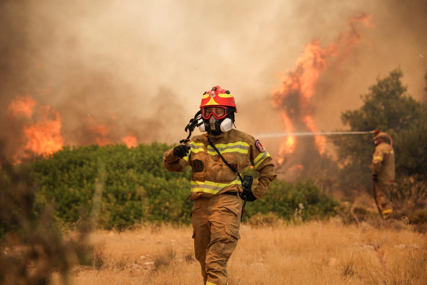 Firefighters work to extinguish a wildfire.