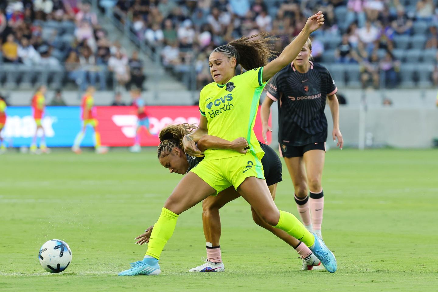 Trinity Rodman battles Sarah Gorden on the soccer pitch.