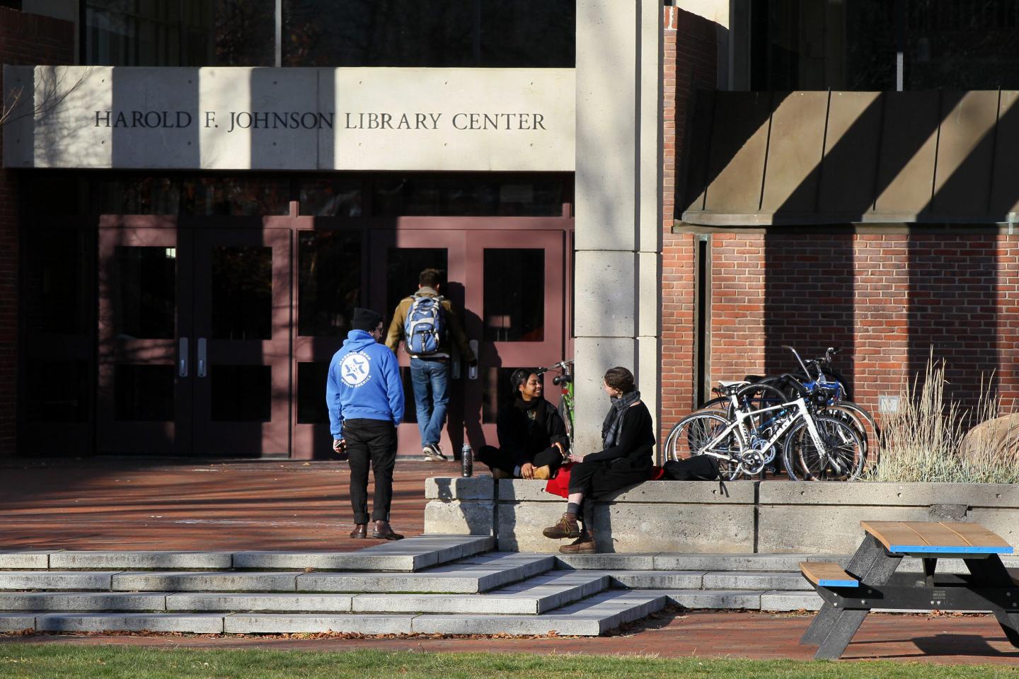 Students gather outside the library at Hampshire College in Amherst, Massachusetts, in 2016. The private liberal arts college is set to end academic operations after the fall 2026 semester.