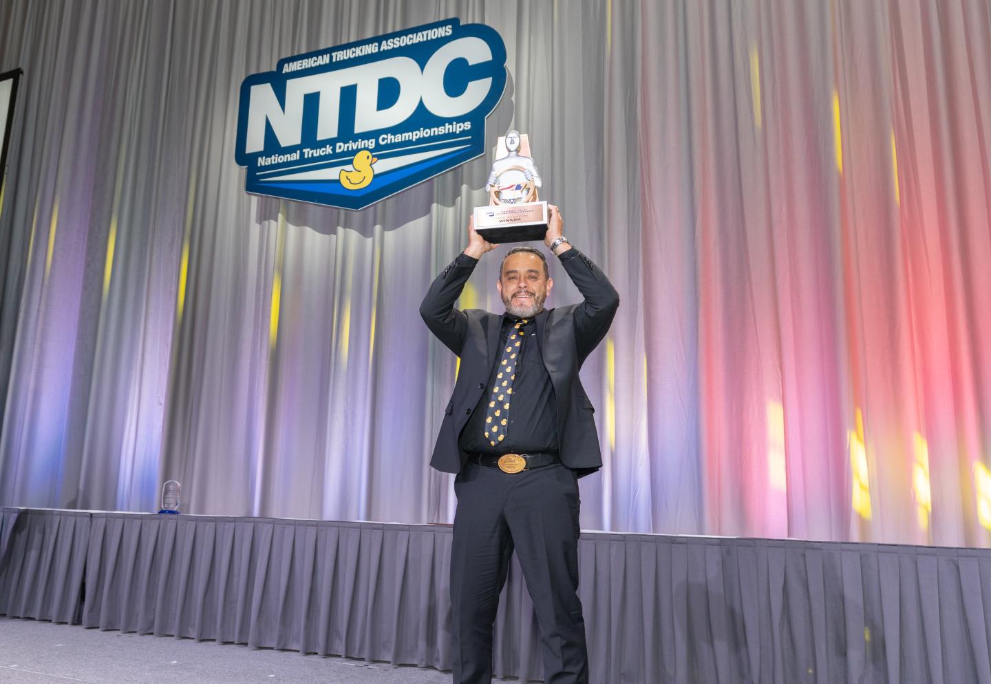 Miguel Corral holds up a trophy after being named grand champion.