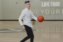 Yevgeny dribbles a basketball