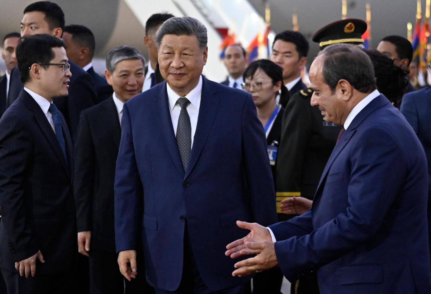 Chinese President Xi Jinping, centre, is welcomed by Egyptian President Abdel-Fattah el-Sissi, right, at Cairo International Airport in Cairo.