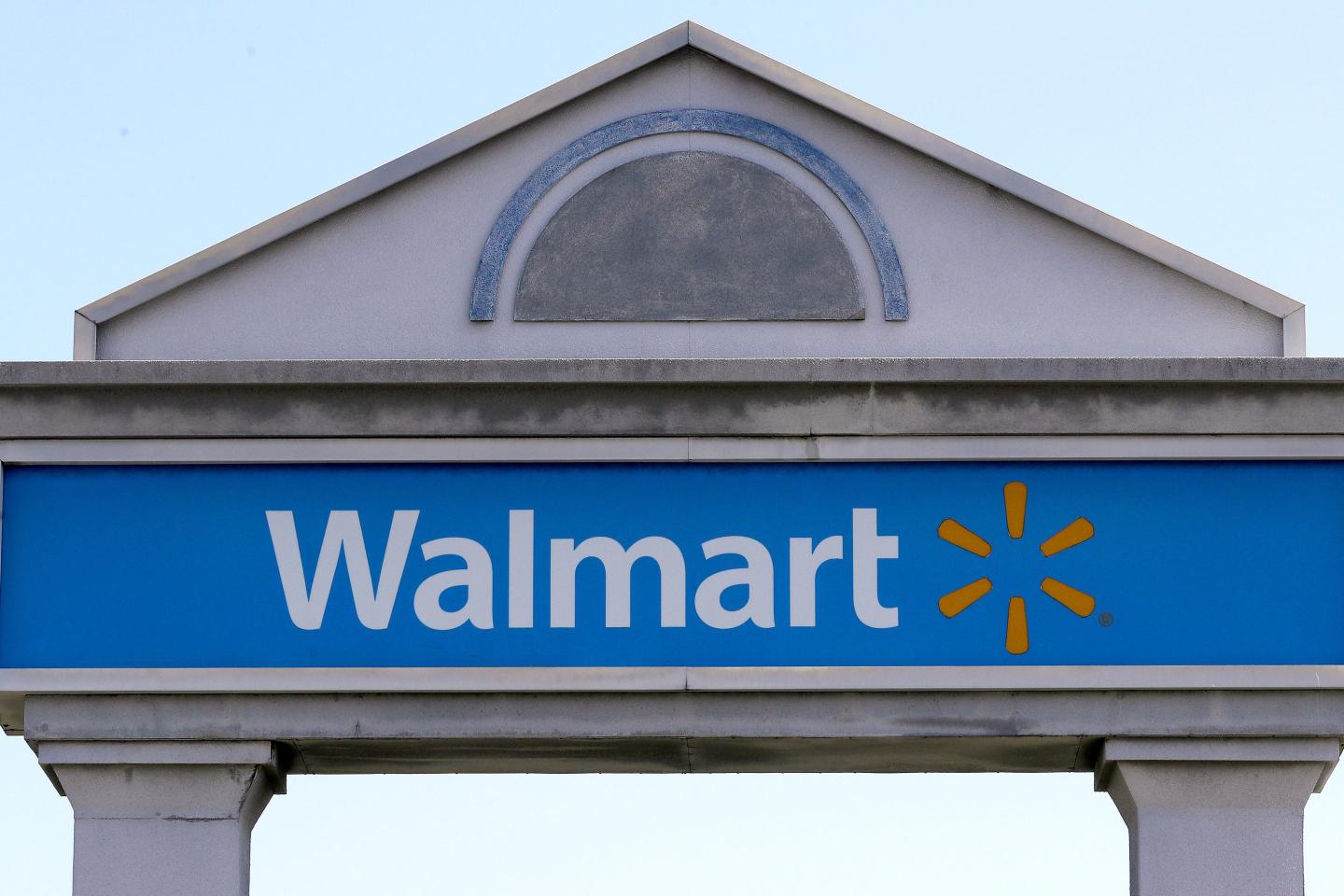 A Walmart sign stands outside a store, Sept. 3, 2019, in Walpole, Mass. 