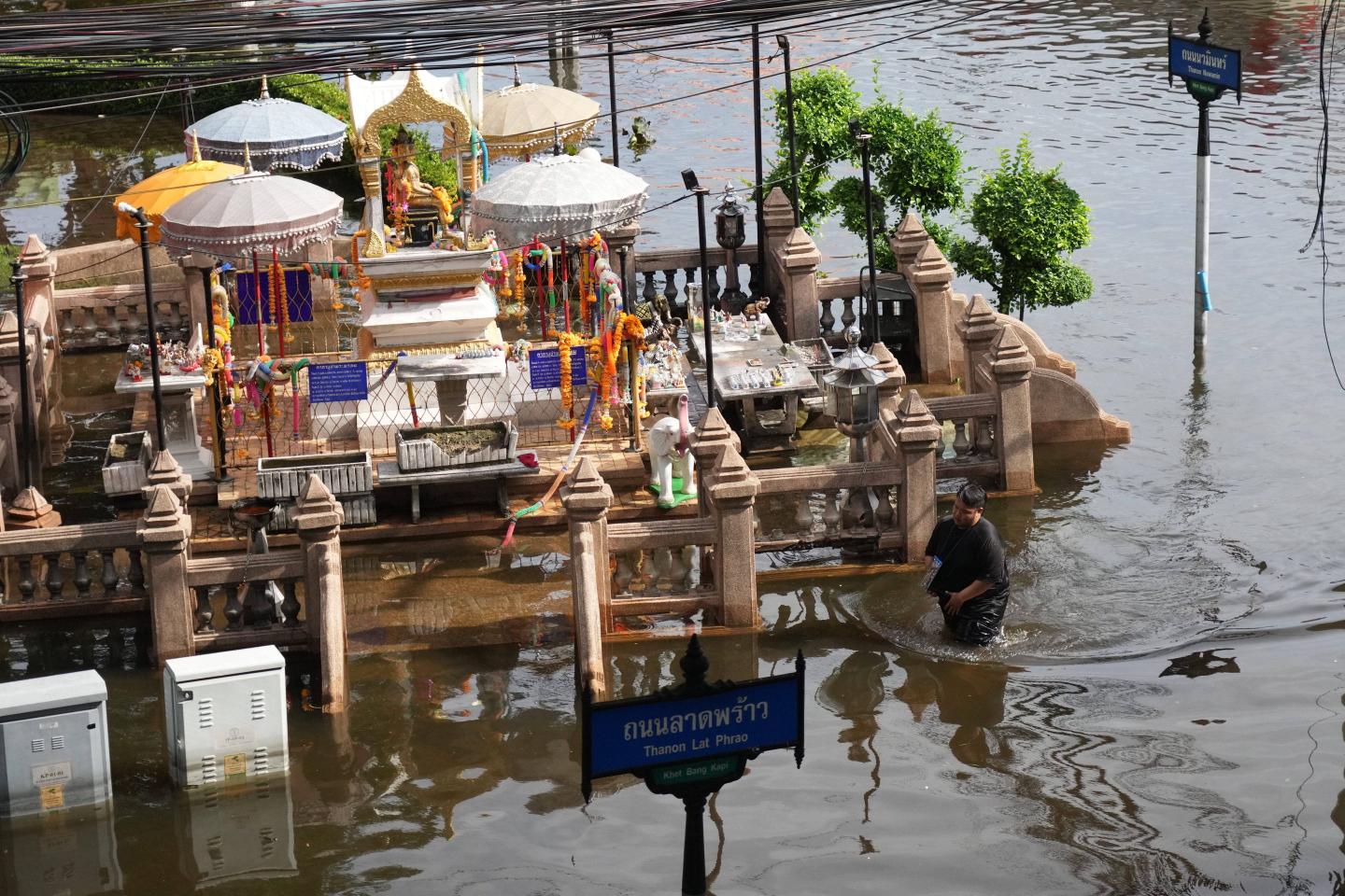 A man wades through floodwaters after heavy rain in Bangkok, Thailand.